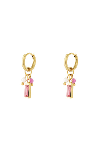 Pair of gold hoop earrings with pink rectangular gemstone, pearl, and pink bead charms on white background