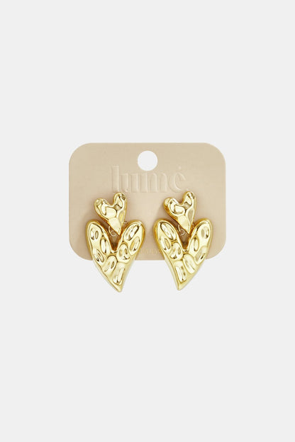 Gold, hammered-texture double heart drop earrings on a branded display card.