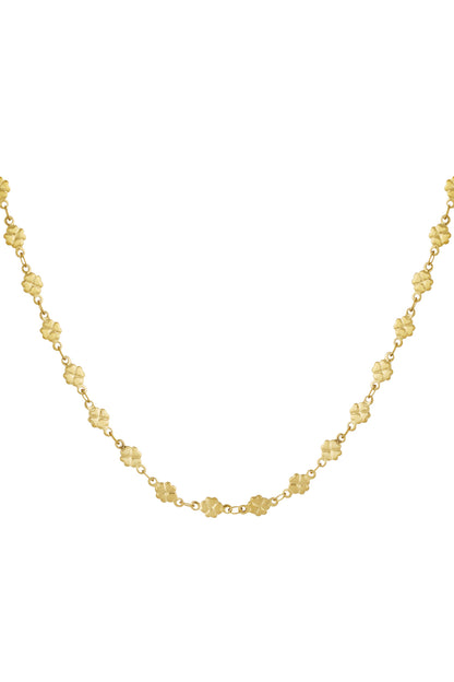 Close-up of a delicate gold-colored necklace with tiny clover-shaped links connected by small chains on white background