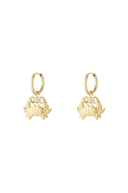 Pair of gold crab-shaped drop hoop earrings with star engravings and pearl detail.