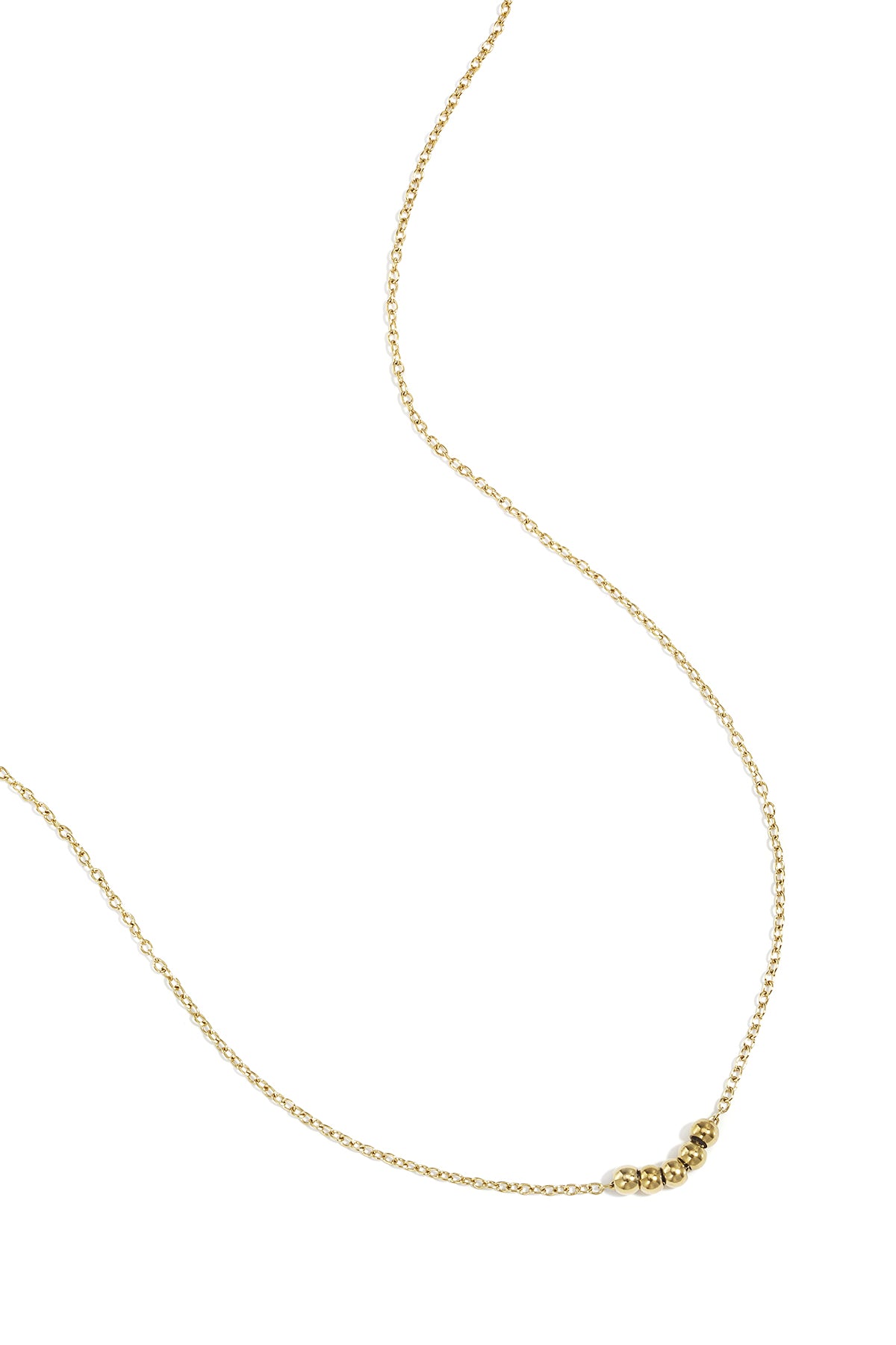 Gold ball chain necklace laid flat on white background displaying chain and five beads