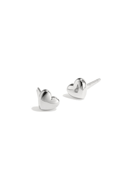 Pair of polished silver heart-shaped stud earrings on white background