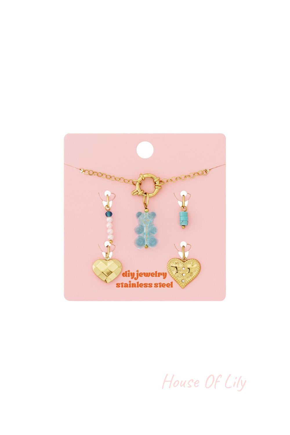Adjustable gold stainless steel charm bracelet with blue bear, turquoise, pearl, and gold heart charms on a pink card.