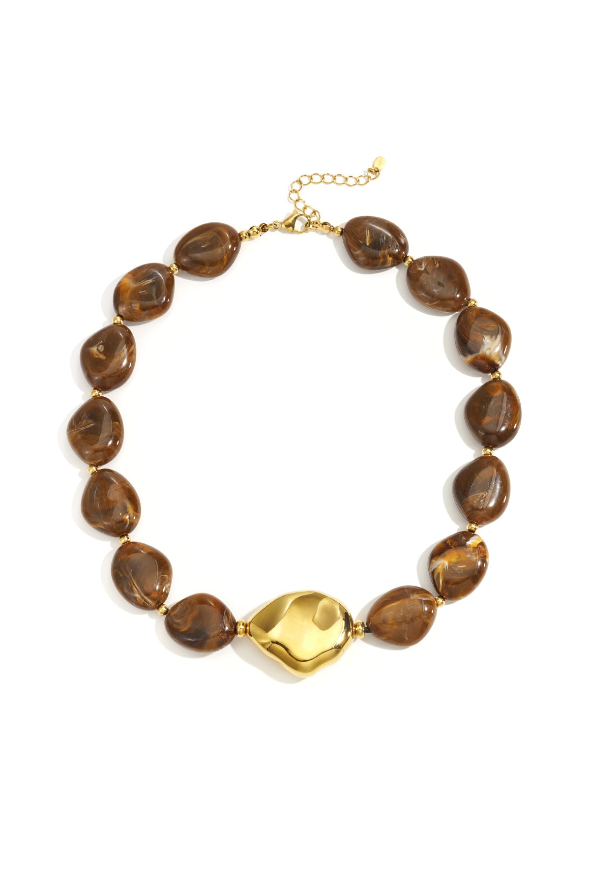 Flat lay image of warm brown acrylic beaded necklace featuring a golden centerpiece against white background