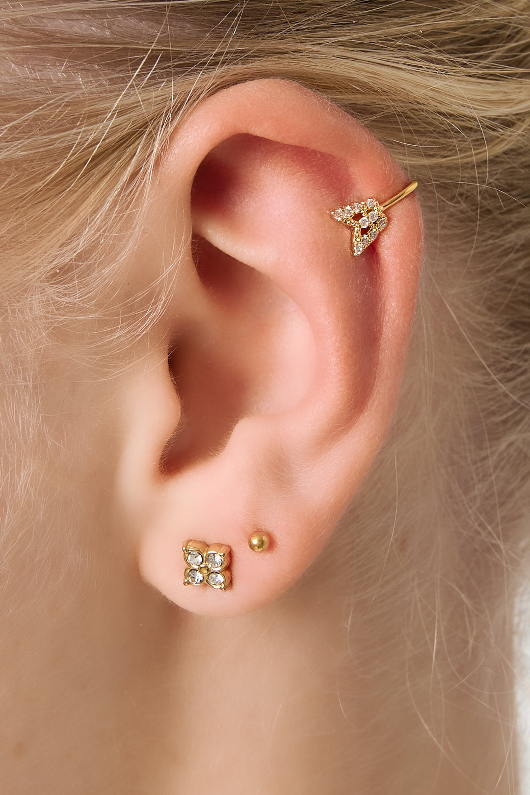 Model's ear adorned with matching gold butterfly ear cuff and earring set, displaying minimal and boutique style