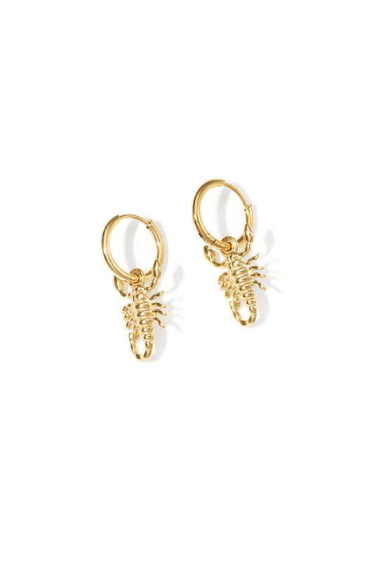 Pair of gold hoop earrings each with a small detailed scorpion charm on a white background