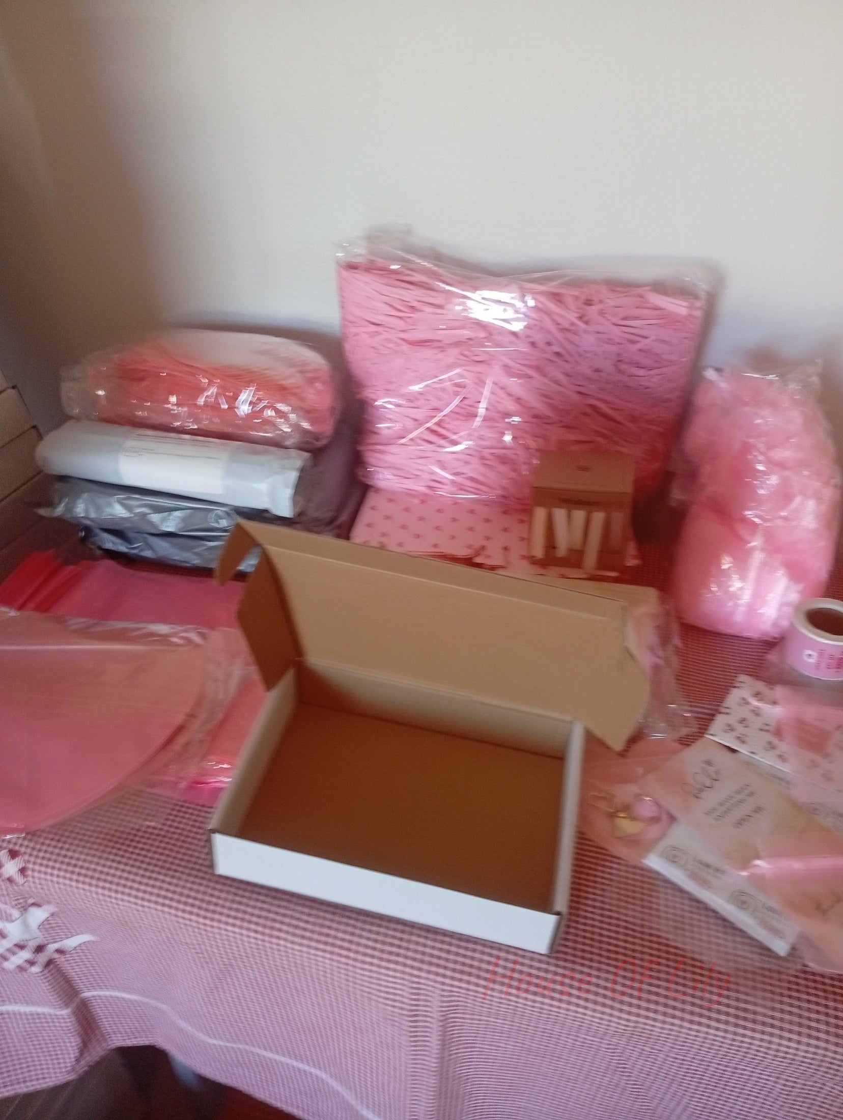 Mystery Box: Launch Edition shown with an open cardboard box, pink filler material, and packaged accessories.