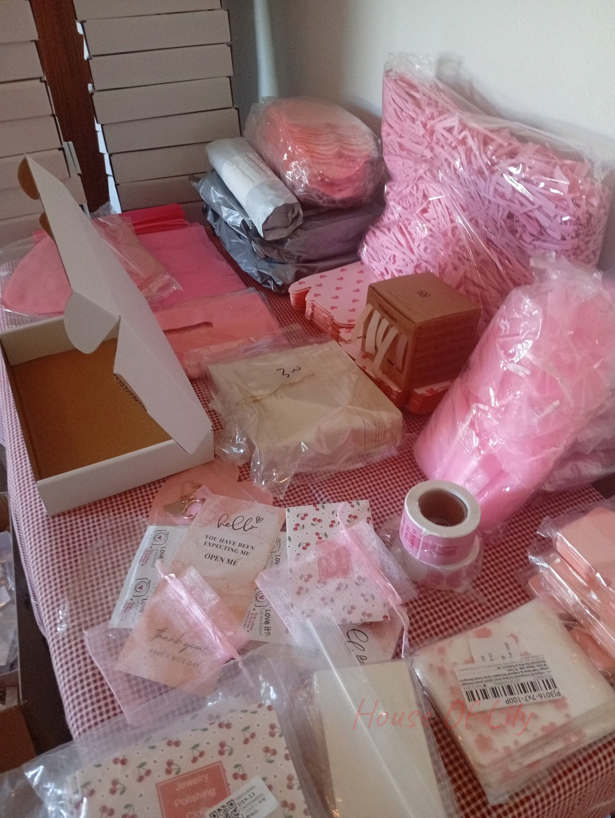 Mystery Box: Launch Edition packaging supplies including pink crinkle paper, boxes, bags, and cards.