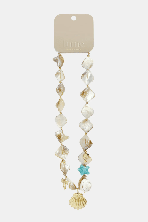 Mother-of-pearl shell necklace with irregular iridescent beads, gold charms, and a blue starfish accent.