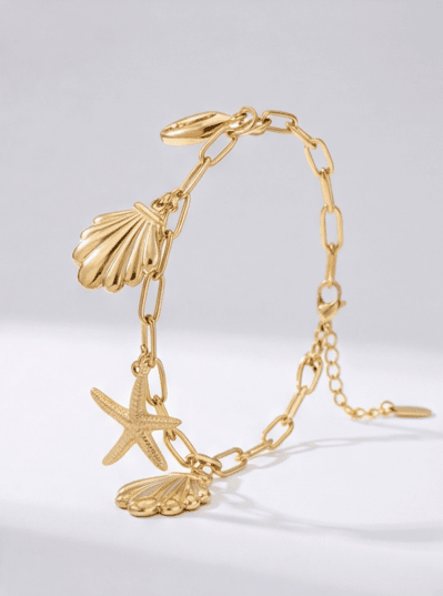 Gold-tone Seaside Charm Bracelet featuring dangling shell and starfish charms on a chunky link chain.