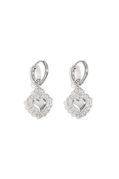 Pair of silver-toned hoop earrings with the same ornate heart-shaped pendants, highlighting polished finish and detailed design