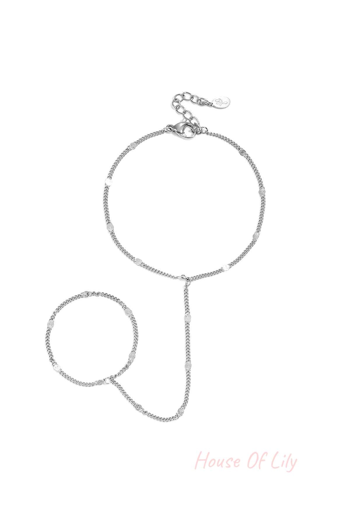Delicate silver chain hand bracelet with small shimmering discs and adjustable lobster clasp
