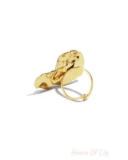 Polished gold ring with a large, abstract, and organically shaped front face.
