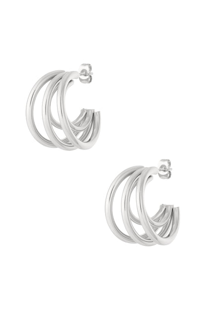 Silver triple hoop earrings displayed against white background showcasing polished finish and intertwined hoops