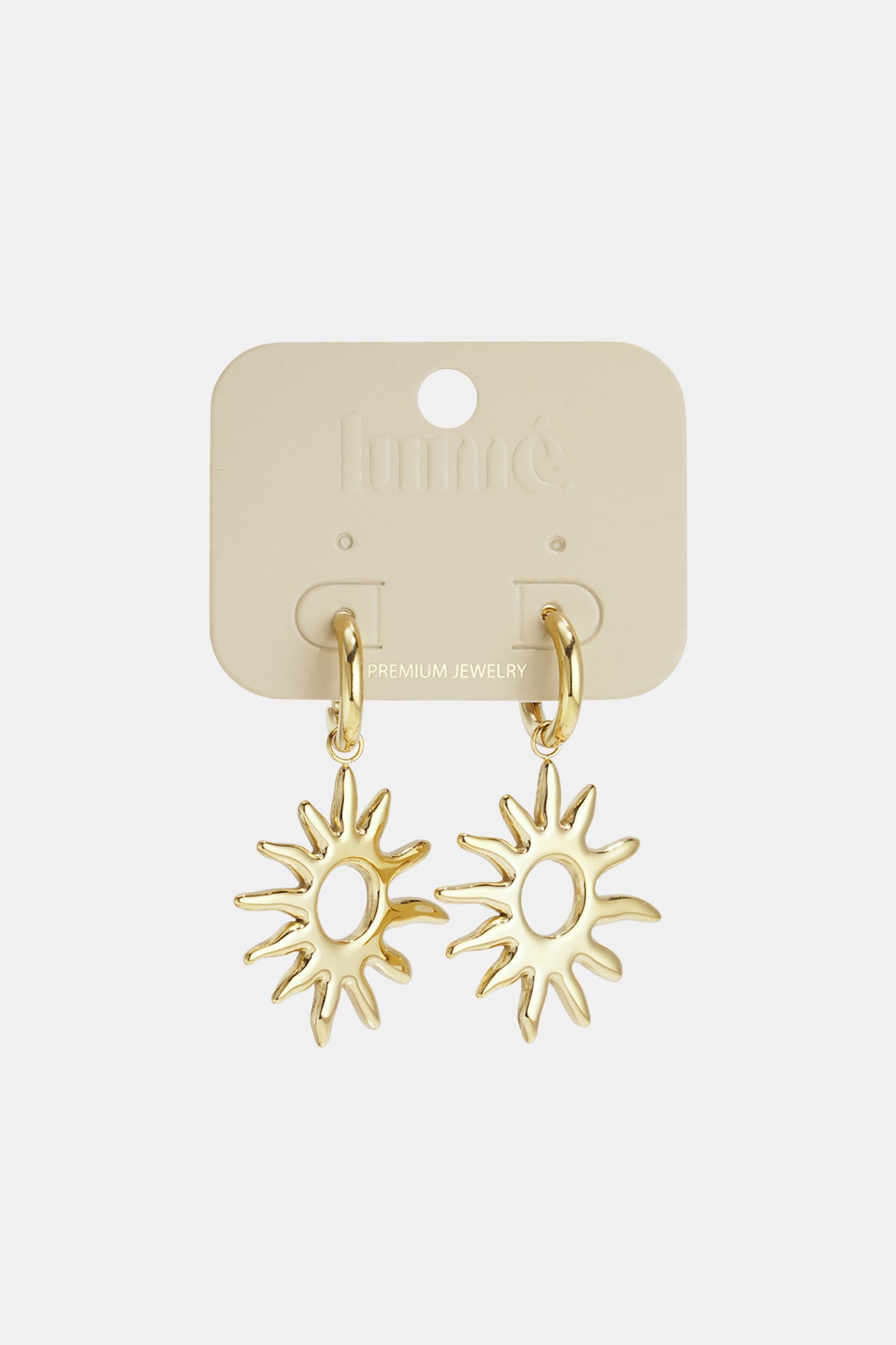 Gold sunburst drop earrings displayed on Lumé premium jewelry card, highlighting polished finish