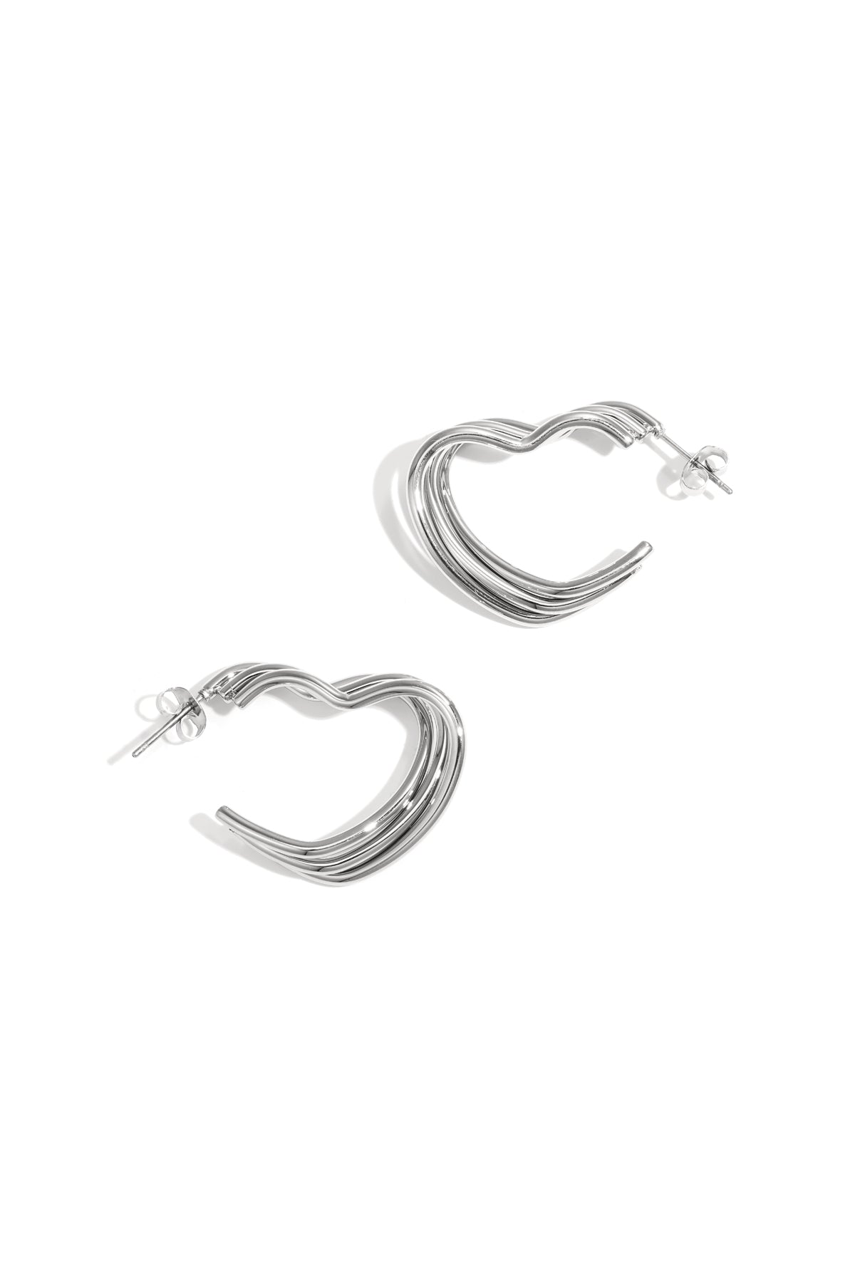 Silver-tone heart-shaped hoop earrings with layered ribbed design on white background