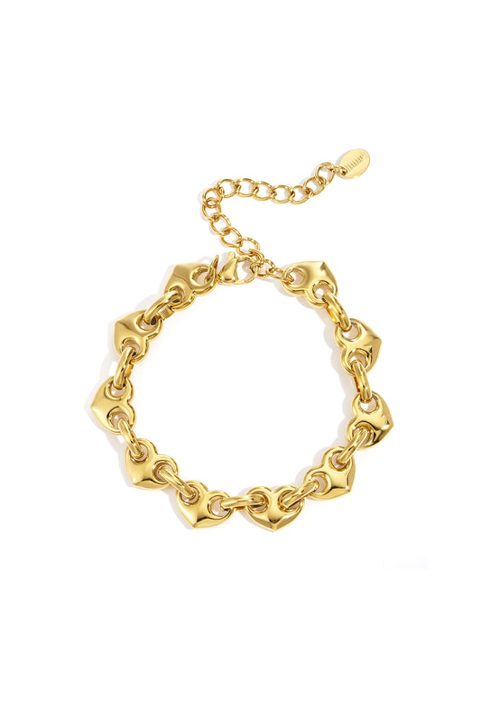 Gold heart-shaped chain bracelet with adjustable clasp laid flat on white background