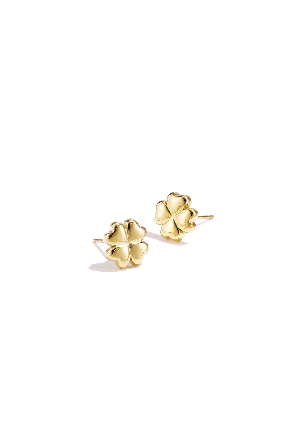 Pair of shiny gold four-leaf clover stud earrings on white background