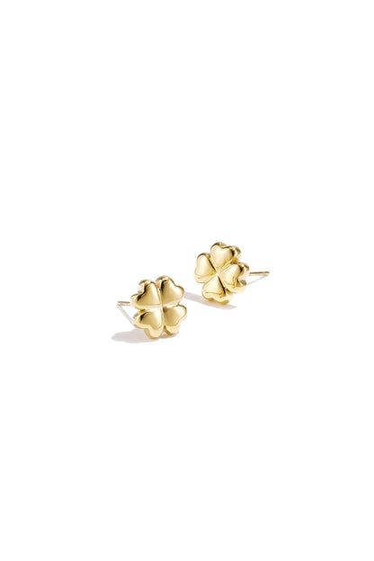 Pair of shiny gold four-leaf clover stud earrings on white background