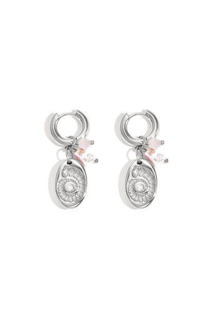 Pair of silver-tone drop earrings featuring a shell medallion charm and pink bead accents on white background