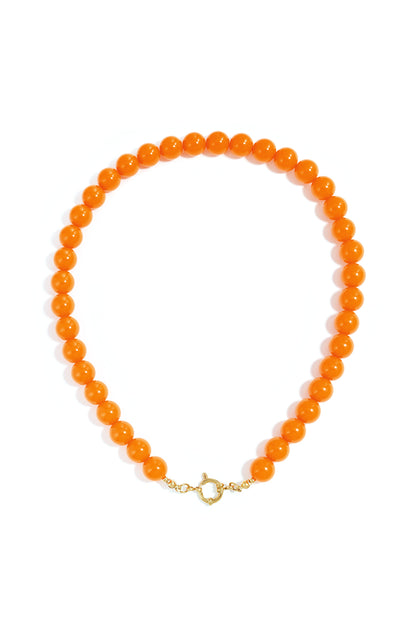 Single-strand necklace of glossy, vibrant orange resin beads with a gold-tone circular clasp, centered on white.