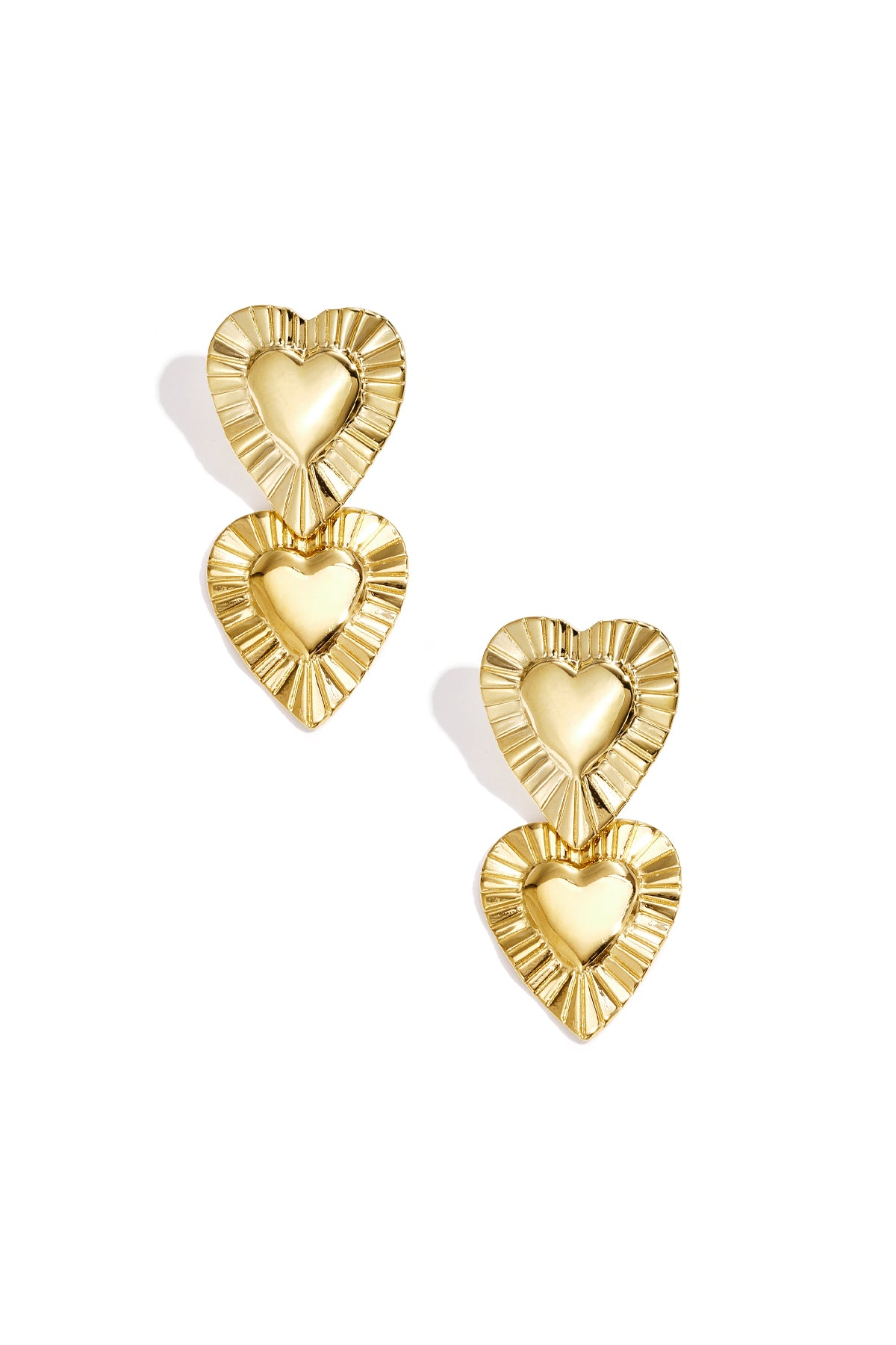 Golden drop earrings featuring two stacked heart shapes with textured, pleated borders and polished centers.