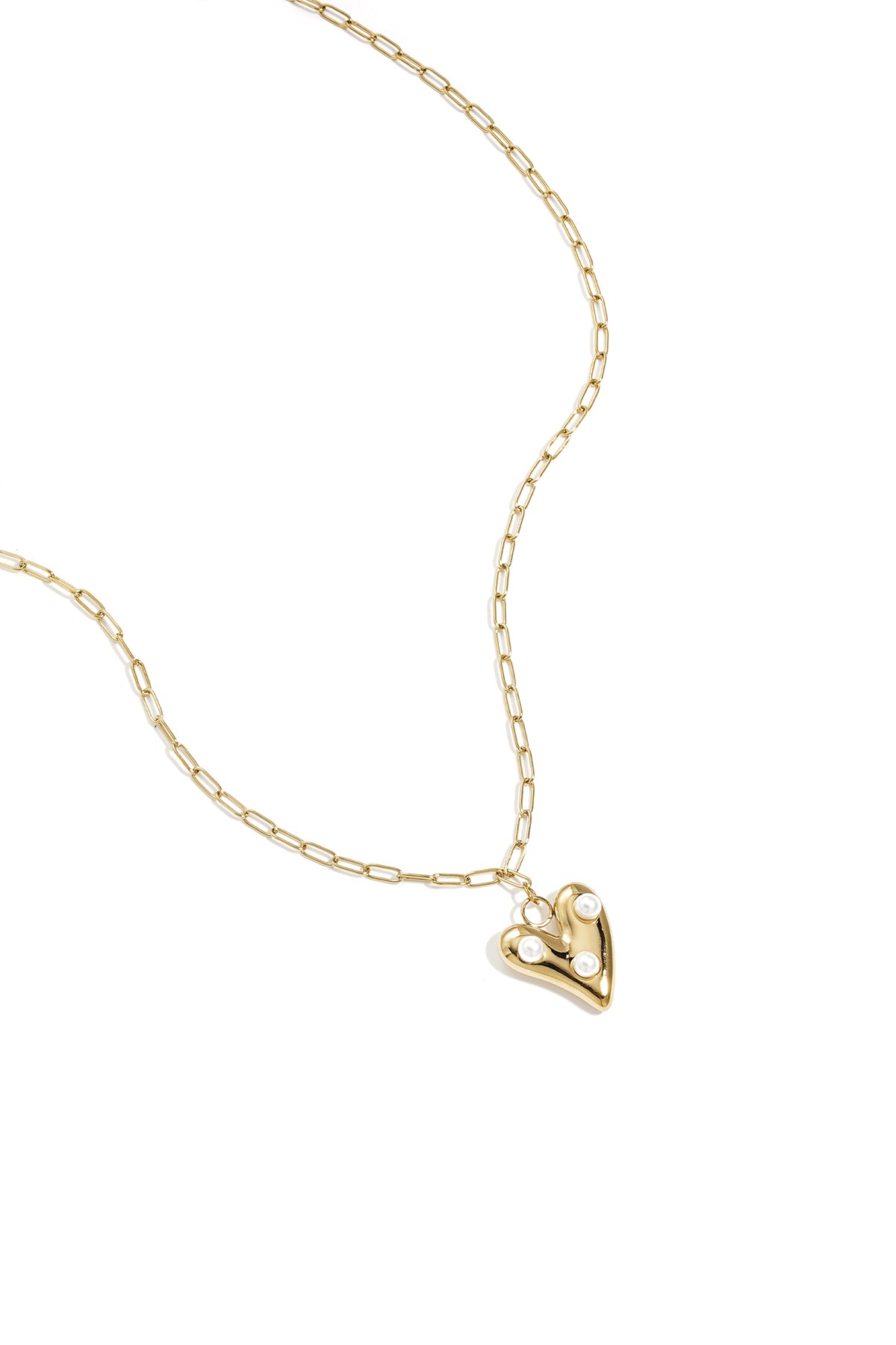 Gold-tone paperclip chain necklace with a heart-shaped pendant featuring three white pearls on a white background