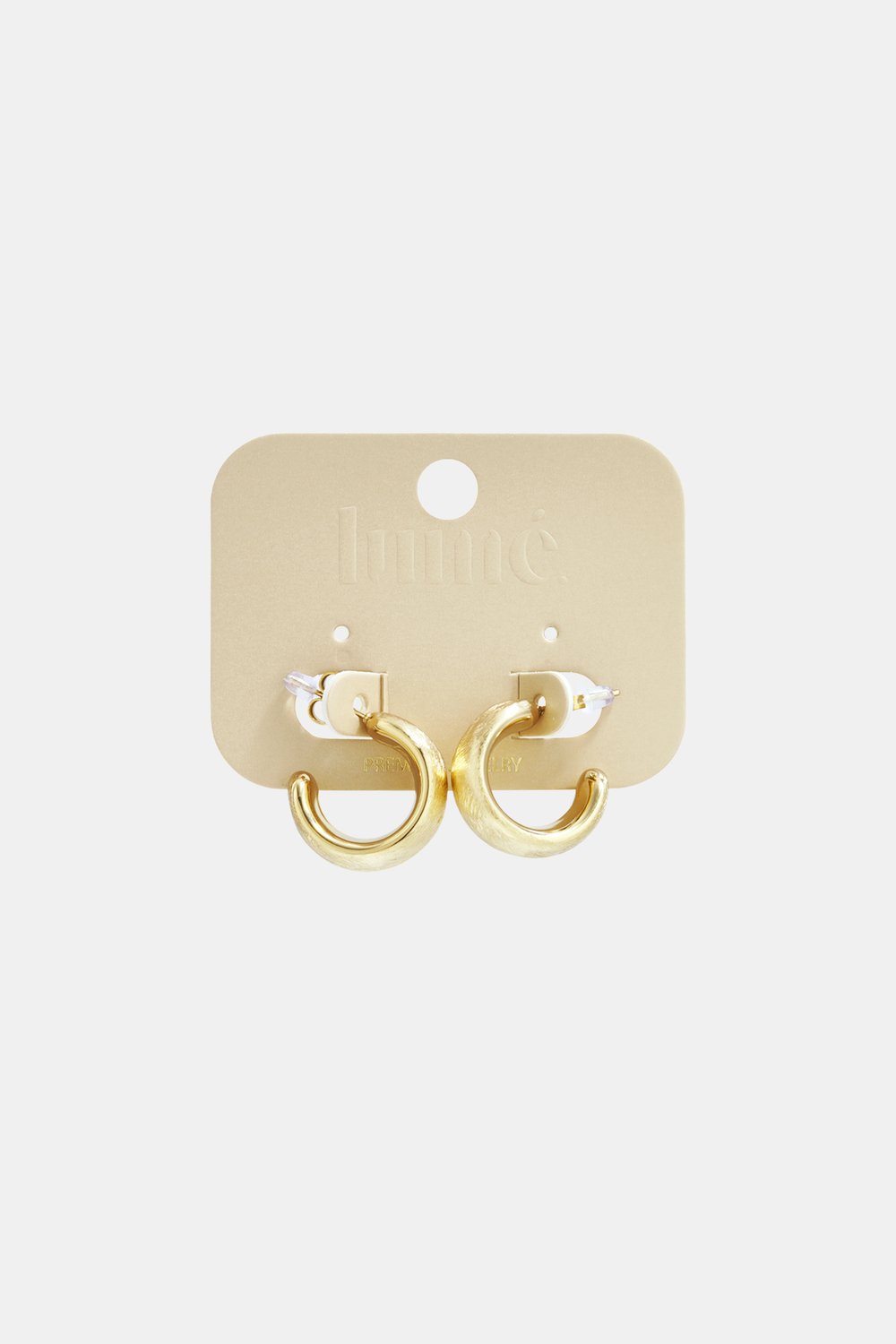 Basic Circle Hoops: Small, thick gold-tone metal hoop earrings with a brushed matte finish on a branded display card.