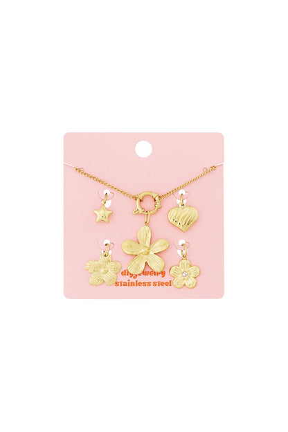 Radiant Crystal Charm Bracelet in gold-tone stainless steel with star, heart, and flower charms on a pink display card.