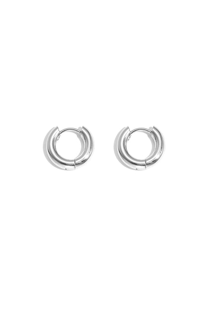 Pair of chunky silver hoop earrings with smooth polished finish on white background