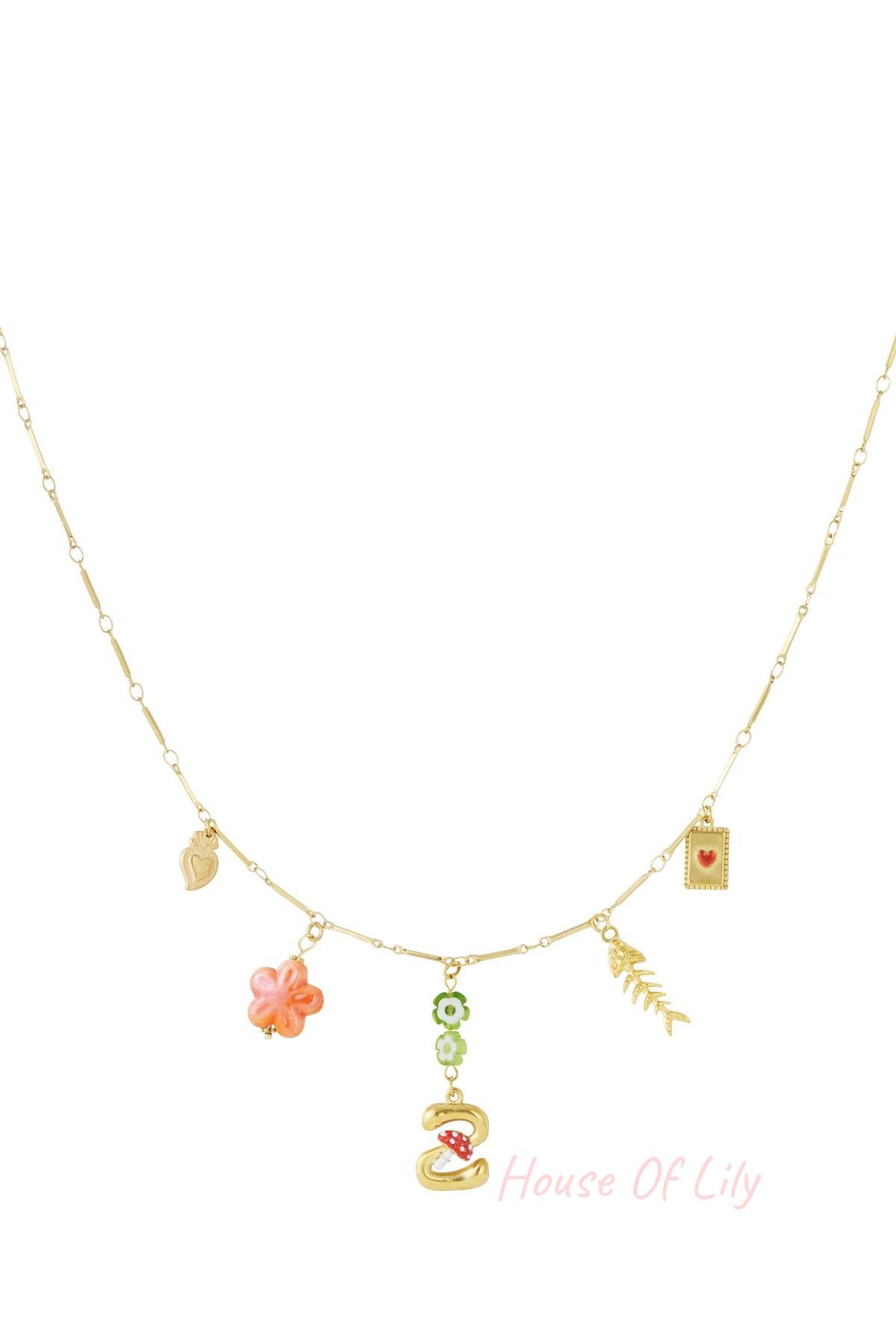 Gold chain necklace with assorted charms, including a letter initial, mushroom, flower, fish skeleton, and heart icons.