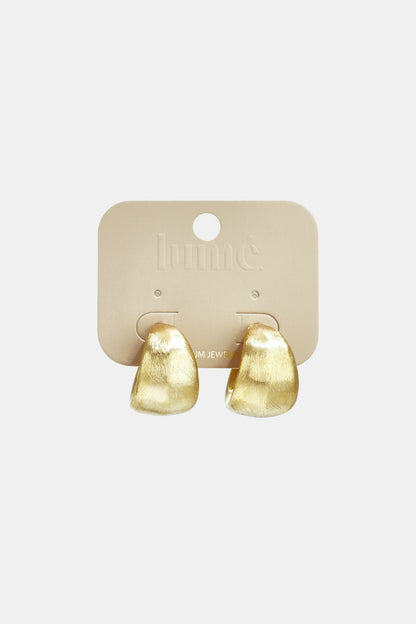 Chunky Aura Loops: pair of small, thick gold hoop earrings with a textured, brushed matte finish on a branded card.