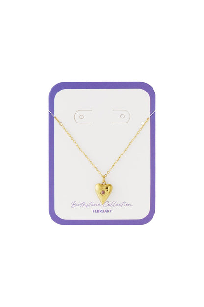 Gold necklace featuring a puffy heart pendant with a small pink February birthstone on a display card.