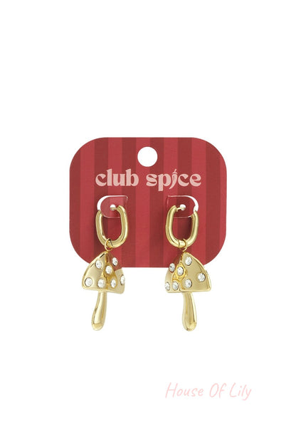 Gold-tone hoop earrings with dangling, crystal-studded mushroom charms on a red striped display card.