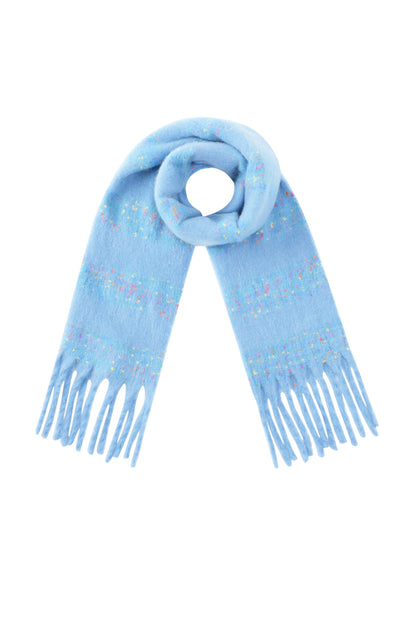 Light blue scarf with confetti speckles and fringed ends laid flat in a looped shape