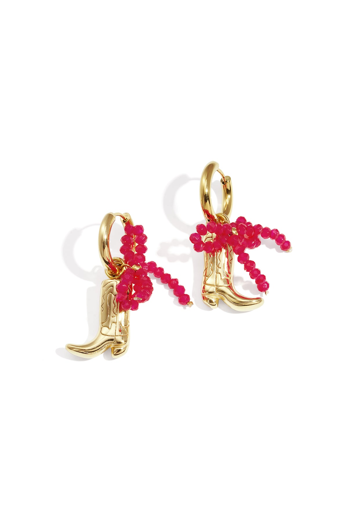 Gold-tone cowboy boot drop earrings with a bright pink beaded bow detail