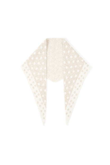 White and beige polka dot triangle scarf folded flat with a soft knit texture