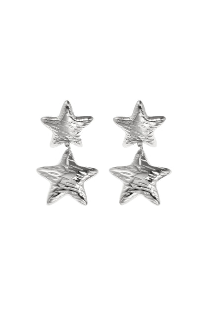 Pair of shiny silver star-shaped double drop earrings with hammered texture on white background