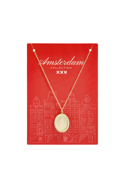 Gold tulip blossom pendant necklace displayed on red Amsterdam Collection card