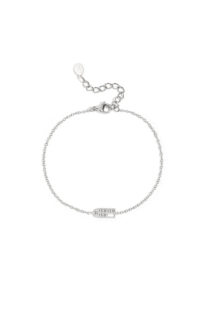 Silver domino charm bracelet with delicate fine chain and adjustable clasp on white background