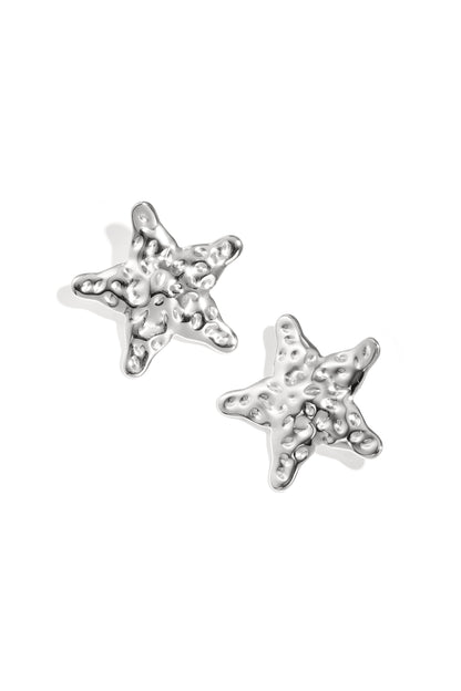 Close-up view of silver textured starfish-shaped stud earrings on white background