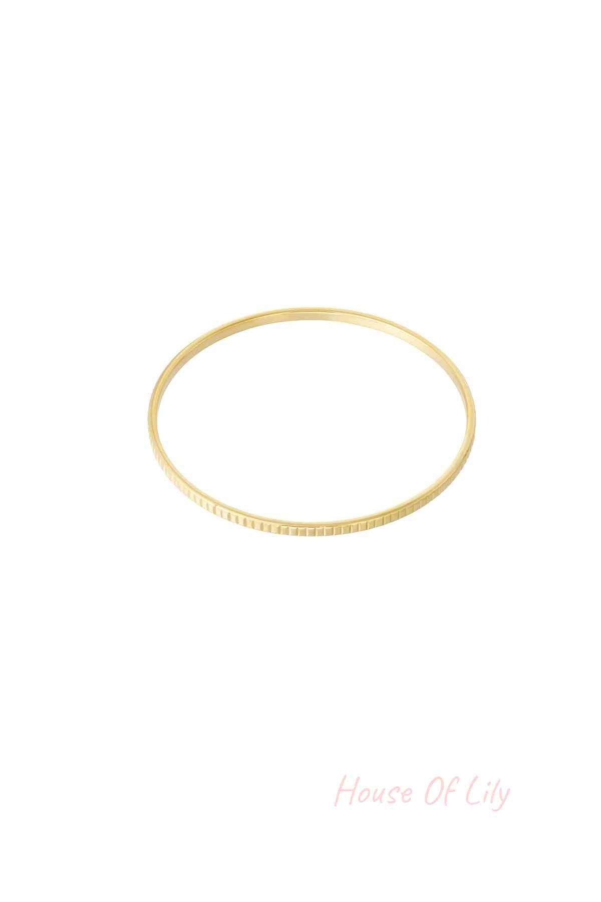 Minimalist gold textured bangle bracelet isolated on white background