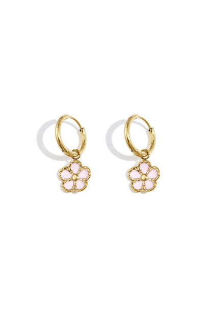 Pair of gold hoop earrings with delicate pink enamel flower charms displayed on a white background