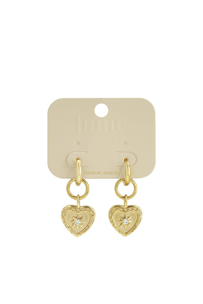 Gold hoop drop earrings featuring heart pendants with intricate filigree borders and a center crystal star inlay.