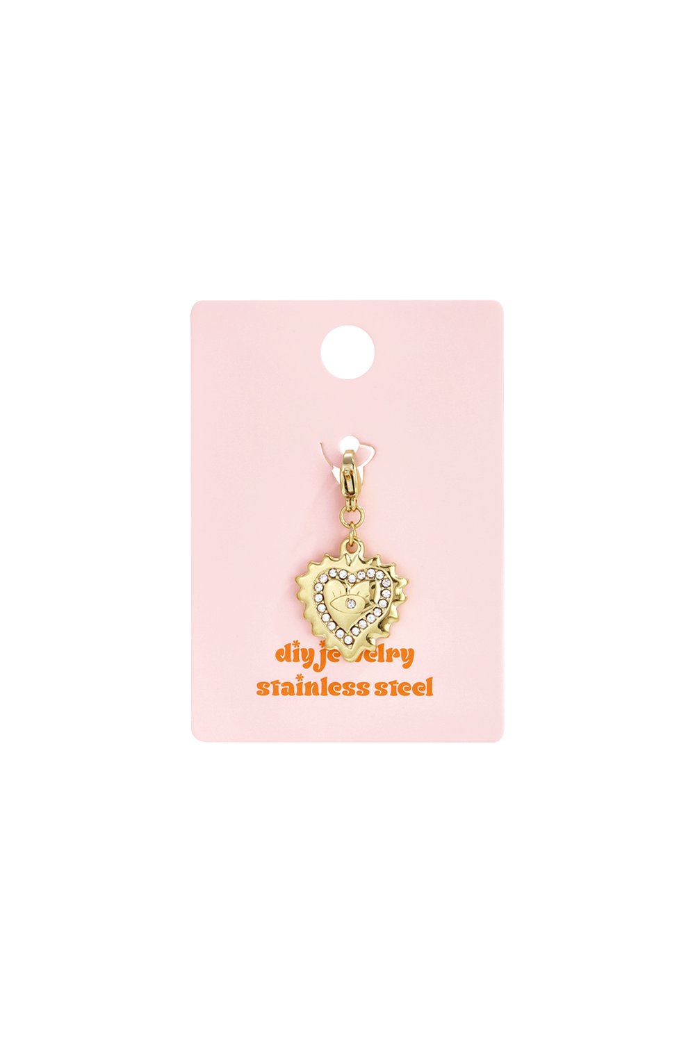 Gold stainless steel heart charm with rhinestone trim and evil eye center on a pink display card.