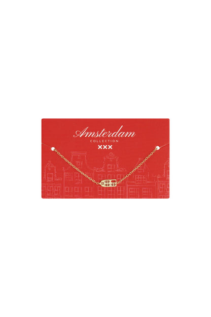 Lucky Domino Vibe gold chain necklace with a small domino-shaped pendant, displayed on a red Amsterdam Collection card.