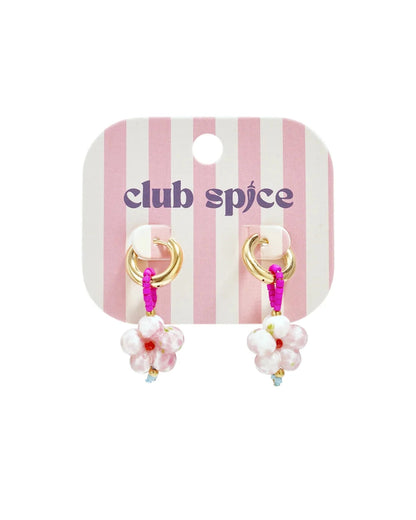 Gold hoop earrings with pink seed-bead loops and pink-and-white glass flower charms on a pink-striped card.