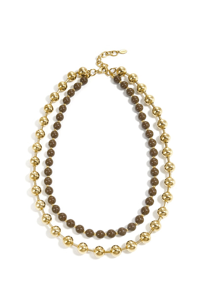 Layered necklace set with chunky gold beads and taupe beads displayed flat on white background with stainless steel clasp