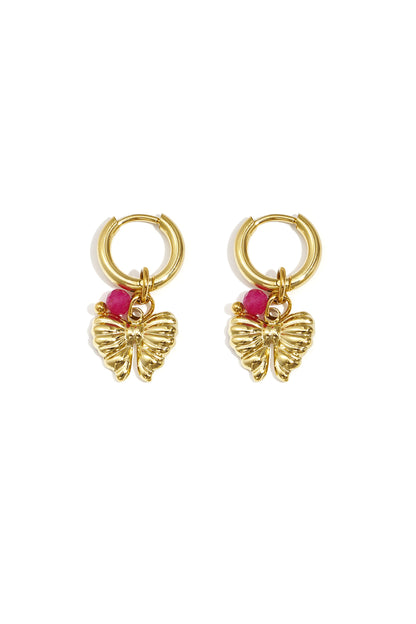Pair of gold hoop earrings with butterfly charms and bright pink beads on white background