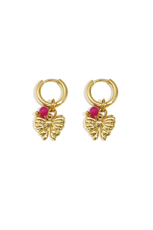 Pair of gold hoop earrings with butterfly charms and bright pink beads on white background